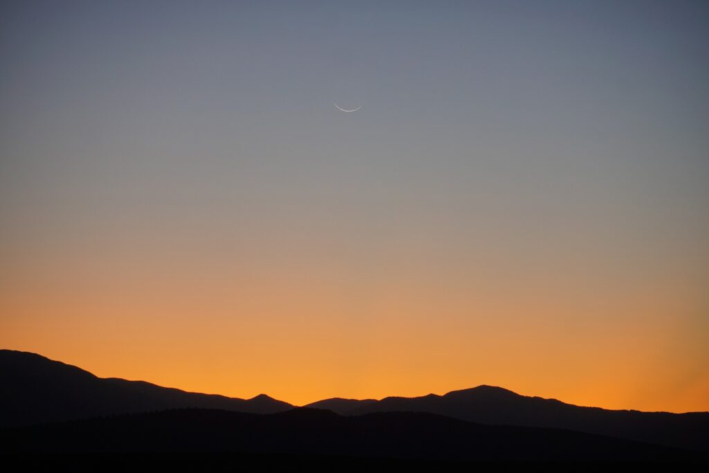 Moon over horizon at sunset